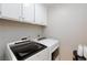 A laundry room featuring a modern washing machine and dryer at 9836 Russett Wood Cir, Las Vegas, NV 89117