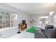 Cozy living room filled with natural light from the large windows and a comfortable seating area at 9836 Russett Wood Cir, Las Vegas, NV 89117