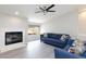 Cozy living room features a fireplace and plush blue seating at 9836 Russett Wood Cir, Las Vegas, NV 89117