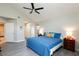 Comfortable main bedroom with a ceiling fan, large windows, and ample storage space at 9836 Russett Wood Cir, Las Vegas, NV 89117