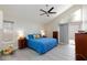 Spacious main bedroom featuring a ceiling fan, large windows, and ample natural light at 9836 Russett Wood Cir, Las Vegas, NV 89117
