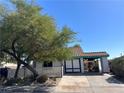 Charming single-story home with a lovely red-tiled roof, mature tree, and an inviting carport at 1731 Paloma Ave, Laughlin, NV 89029