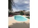 Sparkling in-ground pool surrounded by a concrete patio, perfect for outdoor relaxation and entertaining at 1731 Paloma Ave, Laughlin, NV 89029