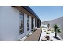 Modern home with sleek lines, large windows, and a desert landscaped walkway leading to the entrance at 652 Dragon Peak, Henderson, NV 89012
