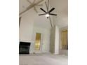Bright living room featuring vaulted ceilings, fireplace, and modern ceiling fan at 2605 S Durango Dr # 204, Las Vegas, NV 89117