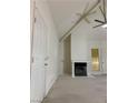 Spacious living room featuring vaulted ceilings, fireplace, and neutral carpet at 2605 S Durango Dr # 204, Las Vegas, NV 89117