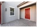 Red front door and gray stone flooring at 5925 Flowering Hill Ct, Las Vegas, NV 89131