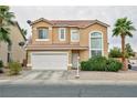 Inviting two-story home with an attached two-car garage, green bushes, rock lawn and well-maintained front yard at 6007 Turtle River Ave, Las Vegas, NV 89156