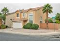 Attractive two-story home featuring a two-car garage, terracotta-tiled roof, and mature palm trees in front at 6007 Turtle River Ave, Las Vegas, NV 89156