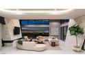 Bright living room featuring comfortable modern furnishings and a wall of windows with skyline views at 4 Horseshoe Rock Ct, Henderson, NV 89012