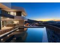 Infinity pool boasting mountain views, an outdoor bar and comfortable lounge seating on the deck at 4 Horseshoe Rock Ct, Henderson, NV 89012