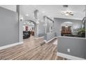 Spacious living room with wood floors and decorative archways leading to other rooms at 8275 W Craig Rd, Las Vegas, NV 89129