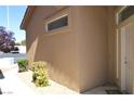 Tan stucco exterior with front door and landscaping at 4727 Wild Draw Dr, North Las Vegas, NV 89031