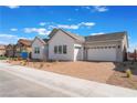 Attractive home showcases a brick driveway leading to a two-car garage under a partly cloudy, vibrant blue sky at 7132 Silver Palace St, Las Vegas, NV 89131