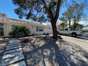 Single-story home featuring a xeriscaped yard, covered entrance, and a two car garage at 611 E Fairway Rd, Henderson, NV 89015