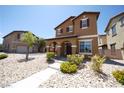 Attractive two-story home with a covered front porch and low-maintenance landscaping at 5713 Heineken Dr, North Las Vegas, NV 89031