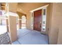 Covered front porch featuring decorative columns and a stylish, solid front door at 5713 Heineken Dr, North Las Vegas, NV 89031