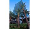 Exterior view of the Martin showcasing modern architecture and lush landscaping including palm trees in the foreground at 4471 Dean Martin Dr # 2205, Las Vegas, NV 89103