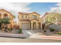 Charming two-story home featuring desert landscaping, a tile roof, and an attached garage at 1161 Gecko Rd, Henderson, NV 89002
