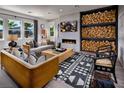 Cozy living room featuring a fireplace and a large wood-stacked wall at 9031 Coastal Oaks St, Las Vegas, NV 89166