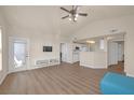 Open living room with vaulted ceilings, wood-look floors, and an open floorplan that includes the kitchen at 10001 Peace Way # 2322, Las Vegas, NV 89147
