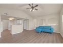 Cozy living room featuring vaulted ceilings, a stylish blue sofa, and wood-look floors for a modern touch at 10001 Peace Way # 2322, Las Vegas, NV 89147