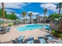Relaxing community pool area with inviting lounge chairs and well-maintained landscaping with palm trees at 10001 Peace Way # 2322, Las Vegas, NV 89147