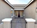 Elegant entryway with a dark brown door and stone accents at 9207 Sandula Ct, Las Vegas, NV 89139