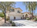 Charming two-story home with a well-manicured front yard and a two-car garage, framed by mature trees at 3179 Surf Spray St, Las Vegas, NV 89117