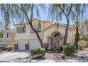 Charming two-story home with a well-manicured front yard and a two-car garage, framed by mature trees at 3179 Surf Spray St, Las Vegas, NV 89117