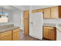 Kitchen with wood cabinets, granite counters, and stainless steel appliances at 8010 Arcadian Ln, Las Vegas, NV 89147