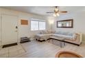 Living room and entryway with L-shaped sofa and light wood floors at 3841 Daisy St # 18, Las Vegas, NV 89119