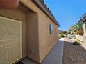 Side view of house showing tan exterior, security door, and walkway at 6072 Corbin Ave, Las Vegas, NV 89122