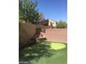 Private backyard with putting green and water feature at 9229 Millikan Ave, Las Vegas, NV 89148