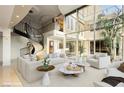 Spacious living room with spiral staircase and large windows overlooking the outdoor courtyard at 3111 Bel Air Dr # 28C, Las Vegas, NV 89109