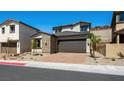 Charming home featuring desert landscaping, brick paved driveway, and two-car garage at 98 Via Franello, Henderson, NV 89011