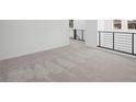 Hallway area features neutral colored carpet, white walls, and modern railing at 98 Via Franello, Henderson, NV 89011