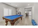 Spacious game room with an ornate pool table under recessed lighting and views of the kitchen at 8351 Gold River Ct, Las Vegas, NV 89113