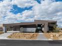 Contemporary home with minimalist design, desert landscaping, and a welcoming front entrance at 12 Chisel Crest Ct, Henderson, NV 89012