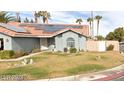 Front view of house with solar panels and landscaping at 2802 Camelback Ln, Henderson, NV 89074