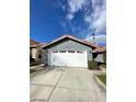 Two-car garage with white door and driveway at 2802 Camelback Ln, Henderson, NV 89074