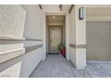 Inviting front porch with modern door, beautiful stone walkway, and neutral stucco at 12295 Skyracer Dr, Las Vegas, NV 89138