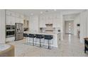 Modern kitchen with white cabinetry, large island, and stainless steel appliances at 12295 Skyracer Dr, Las Vegas, NV 89138