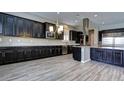 Modern kitchen featuring dark wood cabinets and stainless steel appliances at 1140 Apollo Gardens St, Henderson, NV 89052