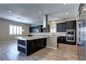 Spacious kitchen with dark cabinetry, granite counters, and island at 1140 Apollo Gardens St, Henderson, NV 89052