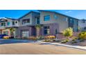 Modern home with stone accents, palm trees, and a three-car garage at 10632 Patina Hills Ct, Las Vegas, NV 89135