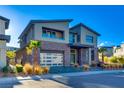 Contemporary home with stone accents and a three-car garage at 10632 Patina Hills Ct, Las Vegas, NV 89135