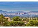 Daytime aerial view showcasing Las Vegas skyline and mountain backdrop at 7090 Fazio Dr, Las Vegas, NV 89110