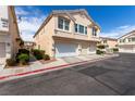 Inviting two-story townhome with a multi-car garage, well-maintained landscaping, and stucco siding at 9333 Leaping Deer Pl # 102, Las Vegas, NV 89178