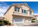 Inviting two-story townhome with a multi-car garage, well-maintained landscaping, and stucco siding at 9333 Leaping Deer Pl # 102, Las Vegas, NV 89178